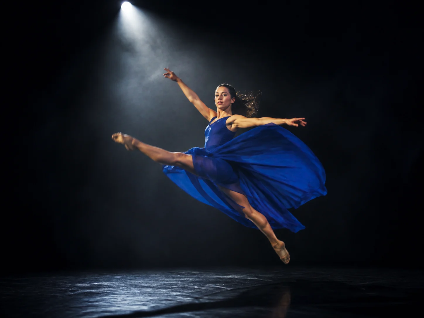 A contemporary dancer captured in a fast full-body turn with readable posture, fabric movement, and cinematic motion blur