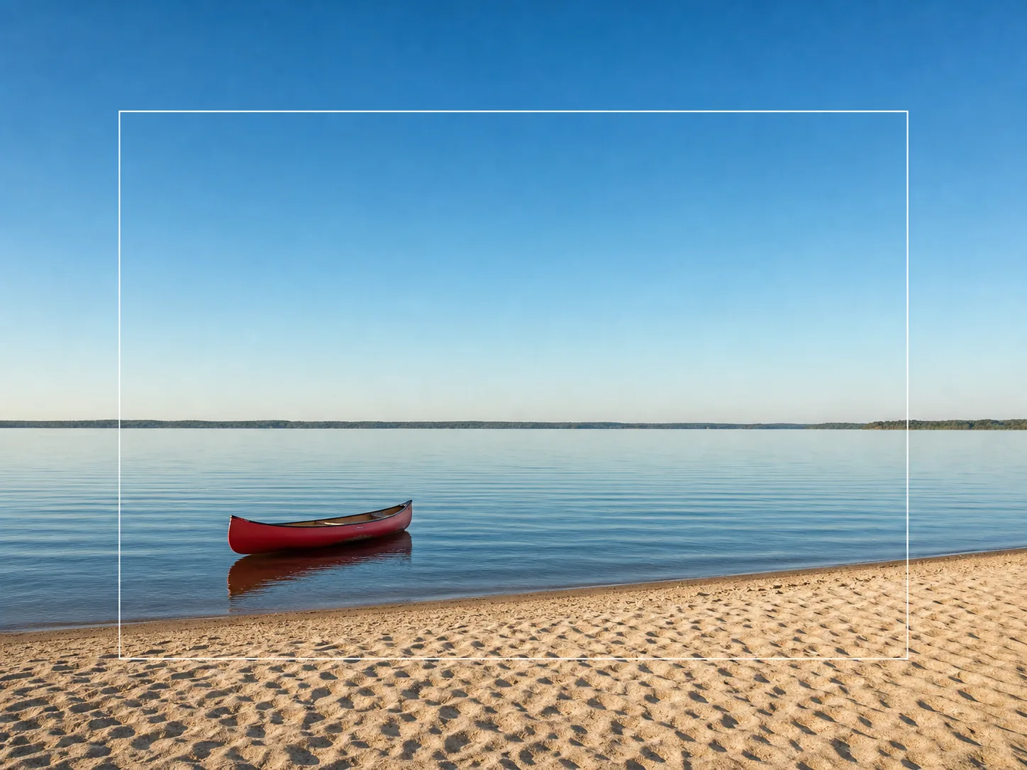 Recommended source boundary surrounded by continuous sky, horizon, water ripples, and sand with the canoe away from the edge