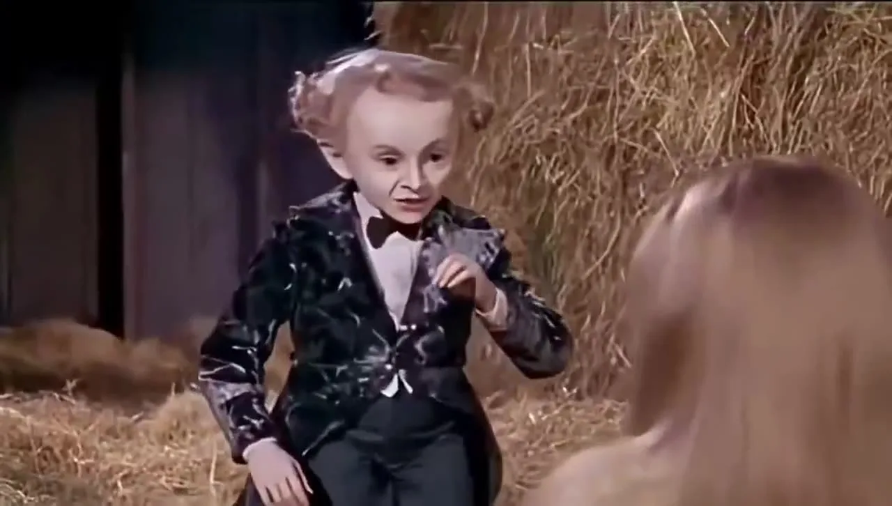 A still from the viral Rumpelstiltskin clip showing warm lantern light, straw and 16mm-style film grain